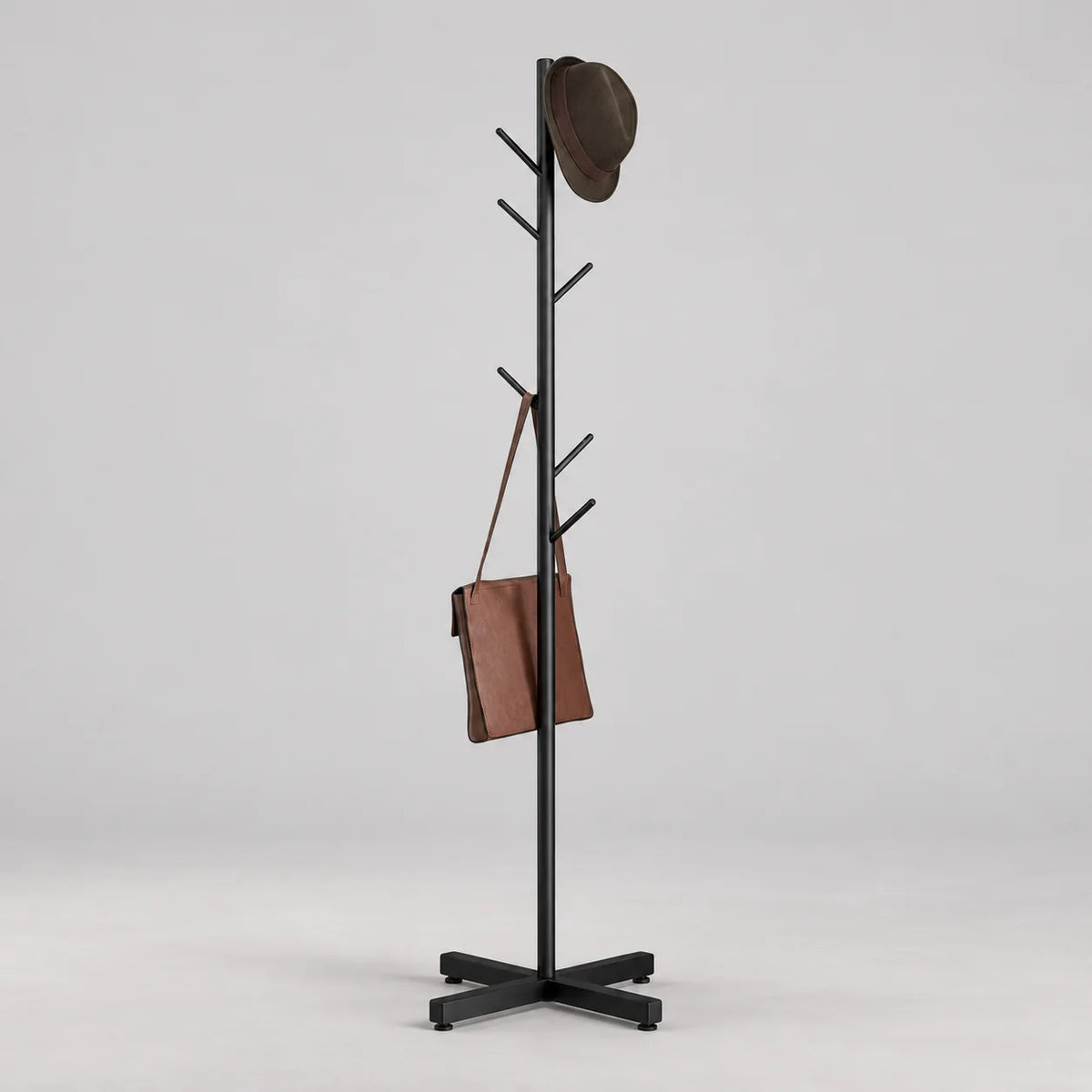 Porte-manteau arbre noir à branches droites et base croisée sur fond gris Image