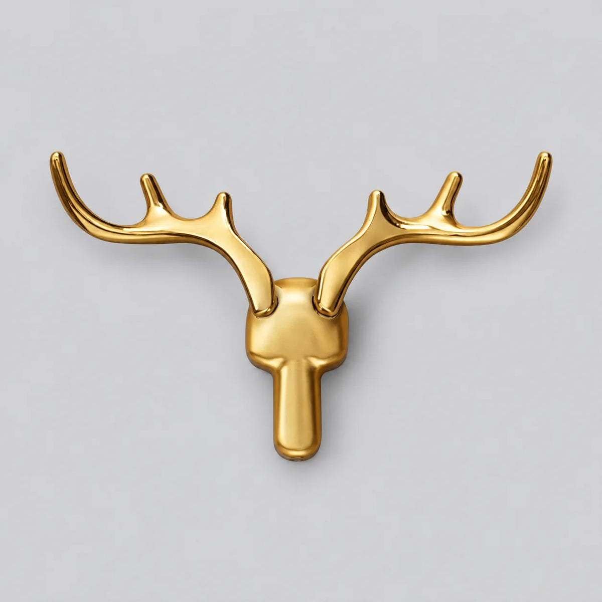 Patère murale cerf dorée en alliage de zinc sur fond gris