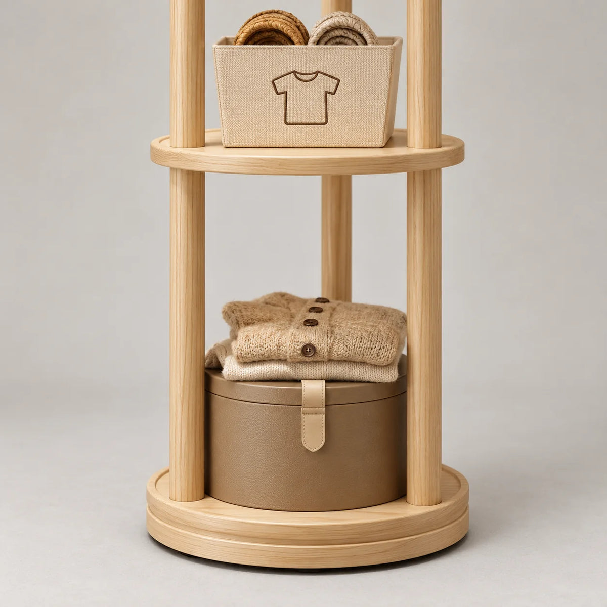 Détail des étagères rondes et des rangements bas du porte-manteau en bois clair
