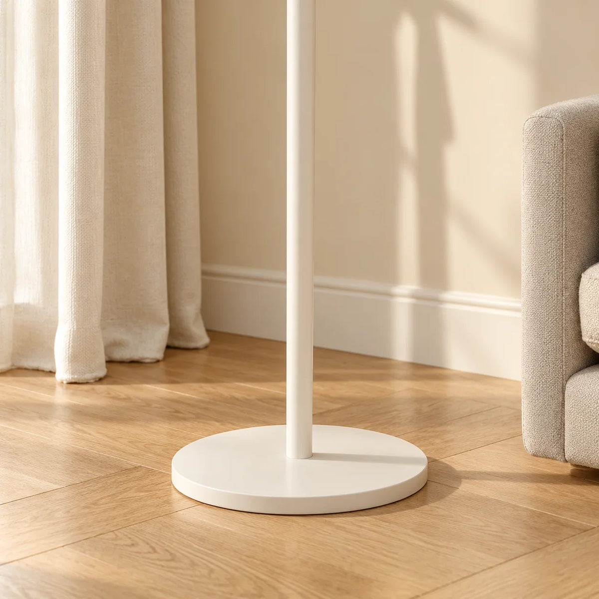 Détail du pied et du socle rond blancs du porte-manteau Nuage