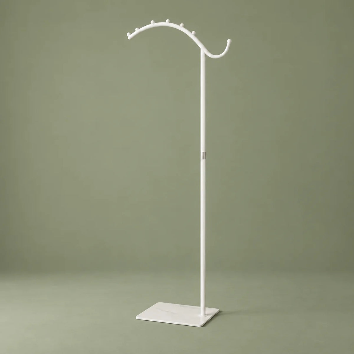 Portant manteau voûté blanc, vue complète sur fond vert sauge