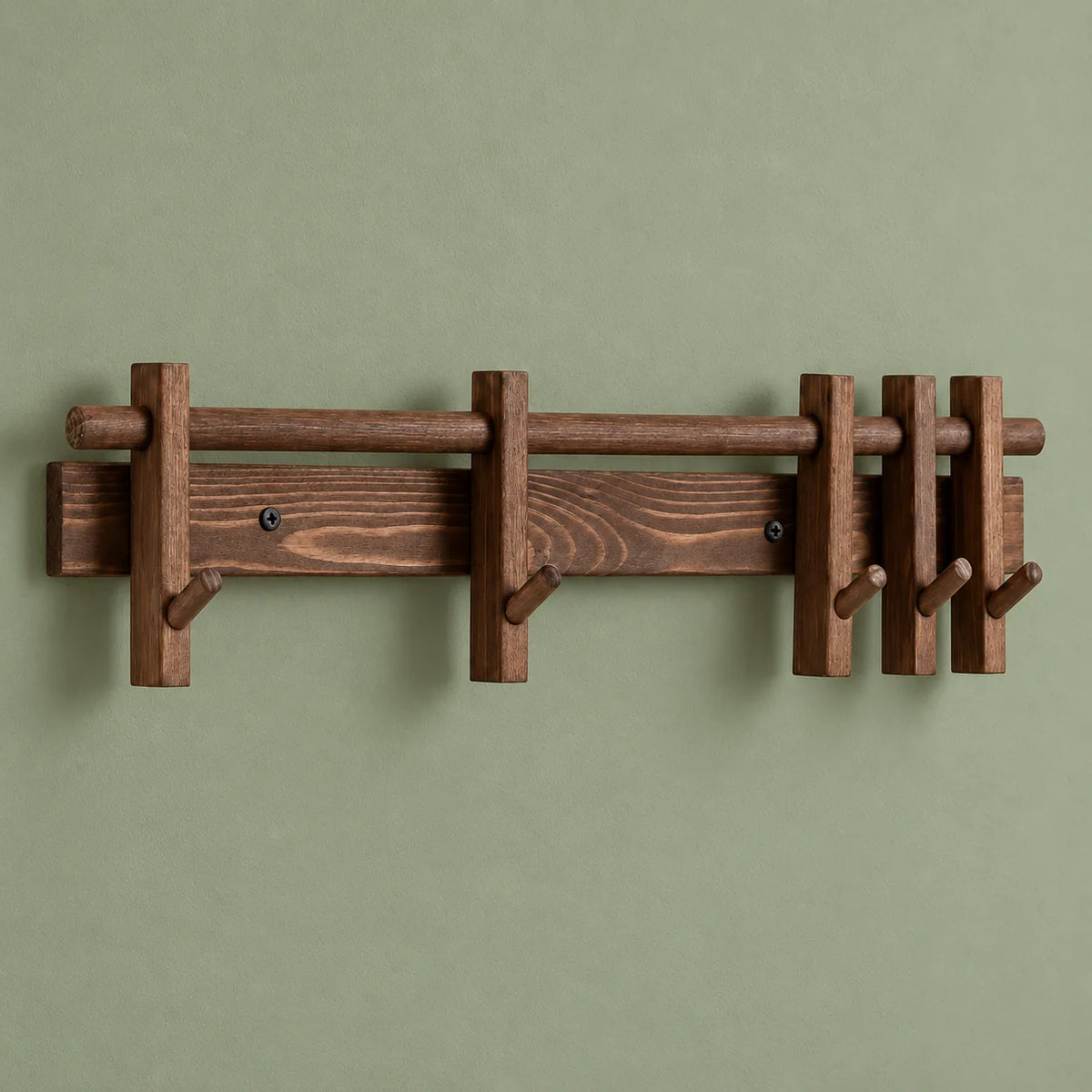 Vue de face du porte-manteau mural en bois marron vide sur mur vert sauge