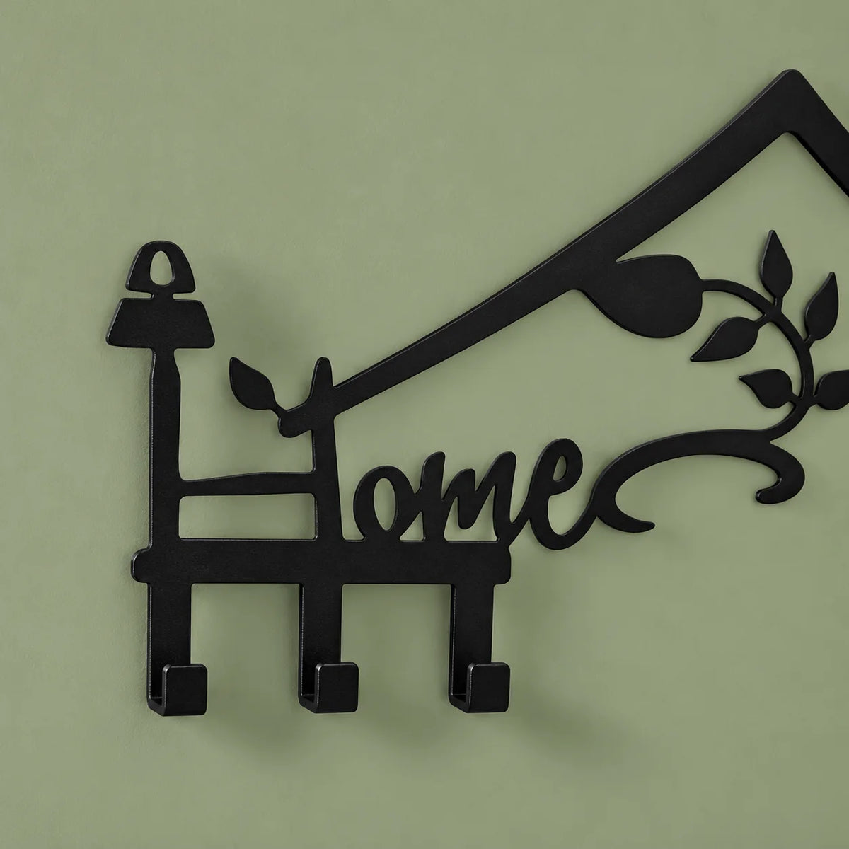 Détail du mot Home, du toit et des trois crochets gauches sur fond vert sauge