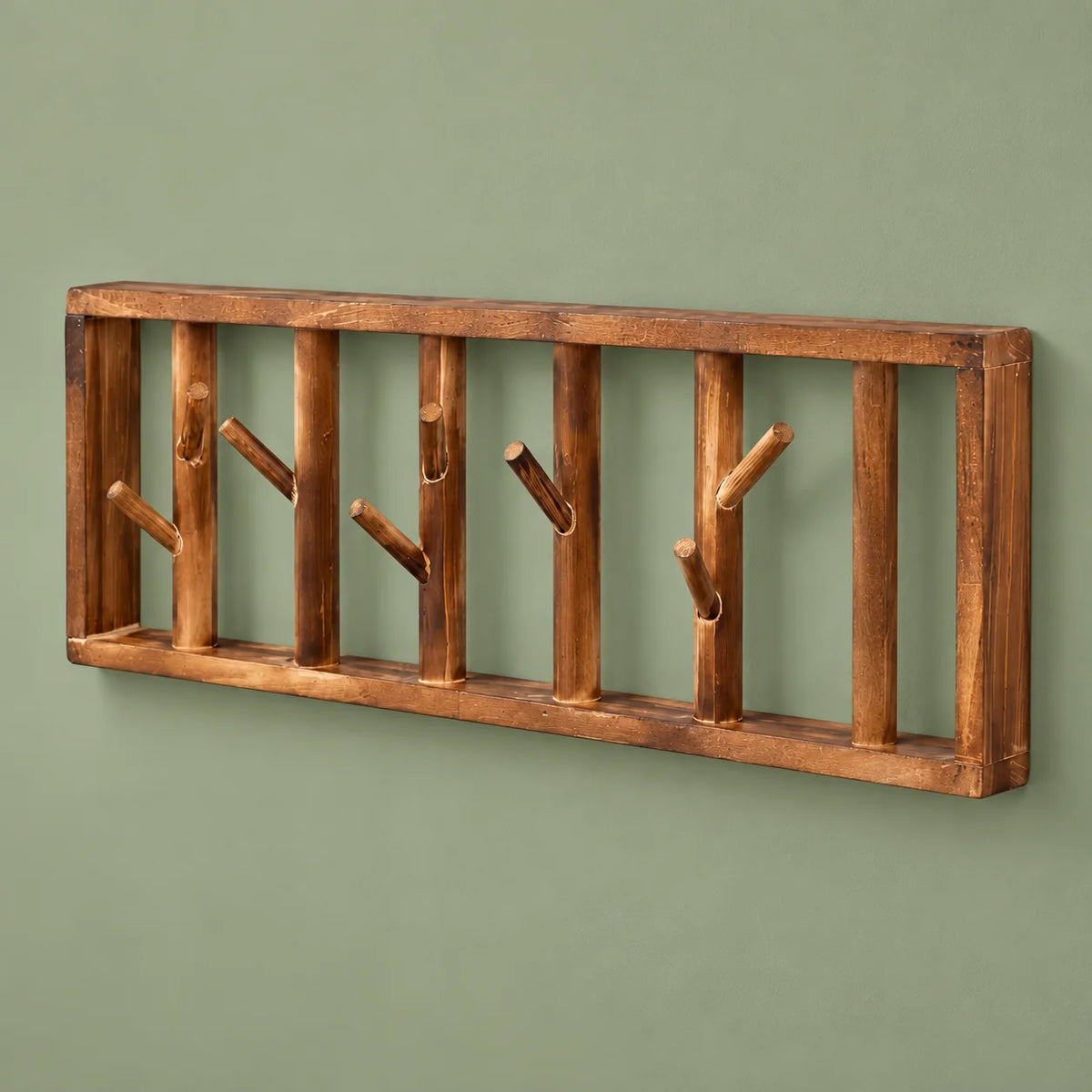 Vue en angle du cadre en bois et des huit crochets du porte-manteau mural Tige Bois sur fond vert sauge